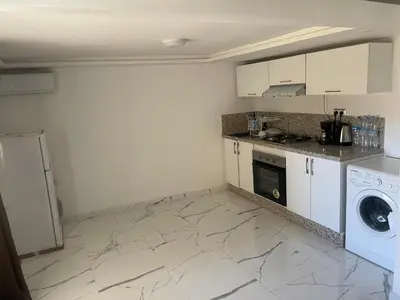 a kitchen with a washer and dryer in a room at Cosy appartement downtown gueliz in Marrakech