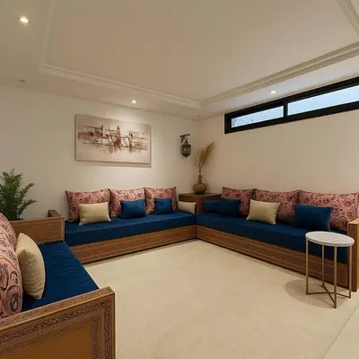 a living room with a blue couch in a room at Studio chic in Marrakech