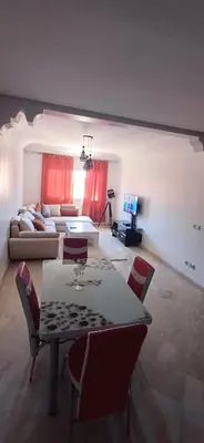 a living room with a table and chairs and a couch at Picasso - Appartement 1 chambre in Marrakech