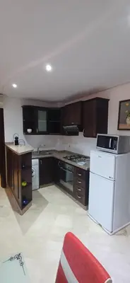 a kitchen with a white refrigerator and a stove at Picasso - Appartement 1 chambre in Marrakech