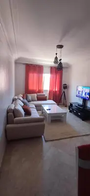 a living room with a couch and a table and a tv at Picasso - Appartement 1 chambre in Marrakech