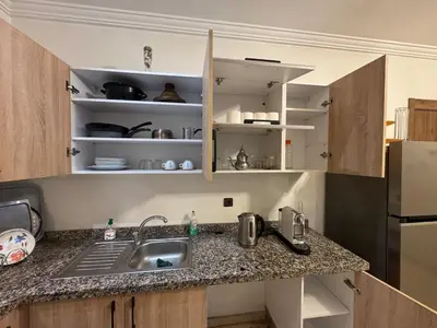 a kitchen with a sink and a counter top at Appartement avec piscine en plein centre de Marrakech in Marrakech