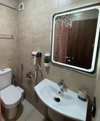 a bathroom with a sink and a toilet and a mirror at Appartement avec piscine en plein centre de Marrakech in Marrakech