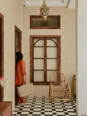 a person standing in a room looking at a door at The Mellah Hotel in Marrakech