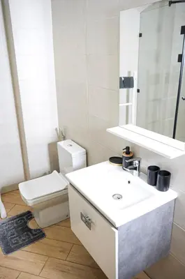 a bathroom with a white sink and a toilet at Vaste duplex neuf modernes et raffiné in Marrakech