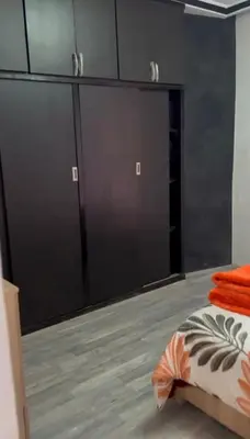 a bedroom with two large sliding doors and a bed at 2-bedroom flat in Gueliz in Marrakech