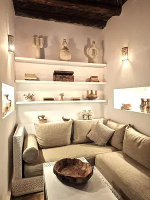 a living room with a couch and a table at Riad Dar El Mahja in Marrakech