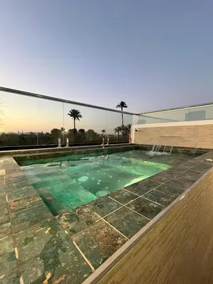 a swimming pool on top of a building at Riad De Luxe Marrakech in Marrakech