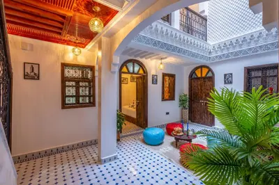 a living room with a ceiling at Riad La Perle Bleue Marrakech in Marrakech