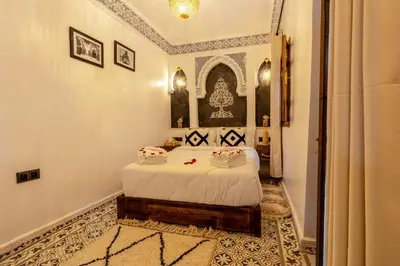 a bedroom with a bed in a room at Riad La Perle Bleue Marrakech in Marrakech