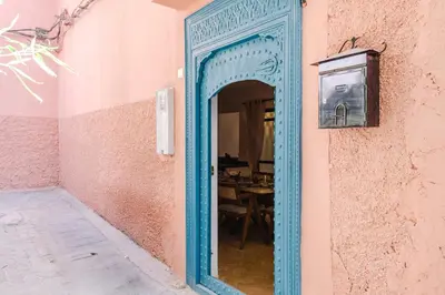 a blue doorway into a room with a table at Riad Chama 10mn from Jamaa Al Fna in Marrakech