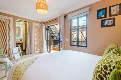 a bedroom with a bed and a large window at Riad Chama 10mn from Jamaa Al Fna in Marrakech