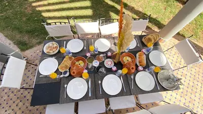 a table with plates of food on top of it at Dar El Hana 4 Bedroom Villa in Marrakech
