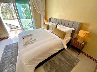 a large bed in a room with a large window at Dar El Hana 4 Bedroom Villa in Marrakech