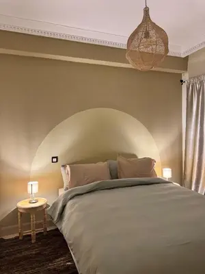 a bedroom with a large bed and a table at Cozy flat in Marrakesh in Marrakech