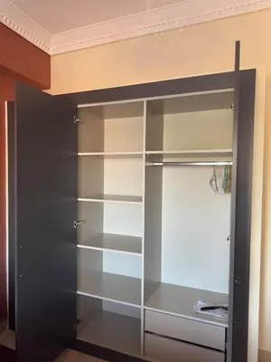 a closet with glass shelves in a room at Cozy flat in Marrakesh in Marrakech