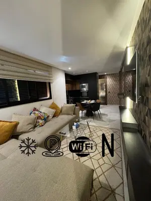 a living room with a couch and a table at Modern and Cozy Apartment Guéliz in Marrakech
