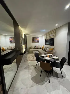 a living room with a couch and a table and chairs at Modern and Cozy Apartment Guéliz in Marrakech