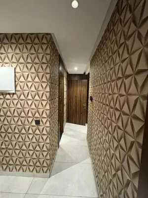 a hallway with a wall covered in brown tiles at Modern and Cozy Apartment Guéliz in Marrakech
