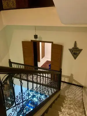 a room with a balcony with a door and a mirror at Maison majid in Marrakech