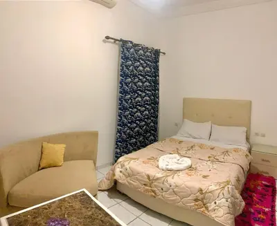 a small bedroom with a bed and a couch at Maison majid in Marrakech