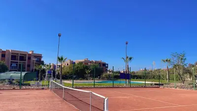 a tennis court with a net on a tennis court at Ben House Palmeraie in Marrakech