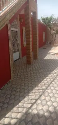 a red building with a gate in front of it at nice mini villa with pool in Marrakech