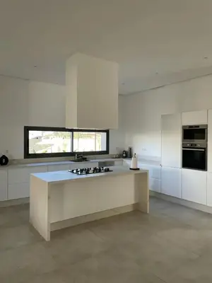 a large kitchen with white cabinets and a counter top at Villa spacieuse à Marrakech avec piscine privée_222 in Marrakech