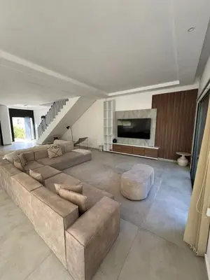 a living room with a large couch and a fireplace at Villa spacieuse à Marrakech avec piscine privée_222 in Marrakech