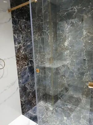 a shower with a glass door in a bathroom at Cosy appartement Victor Hugo in Marrakech