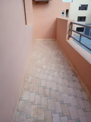 a hallway with a brick floor in a building at Cosy appartement Victor Hugo in Marrakech