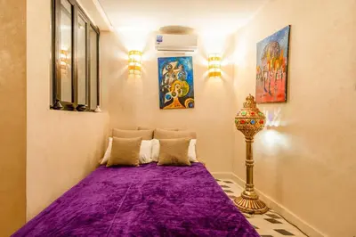 a room with a purple bed with a lamp in it at Dar mehdi in Marrakech