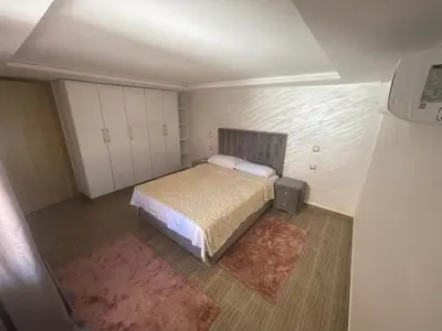 a small bedroom with a bed and white cabinets at Appartement downtown marrakech in Marrakech