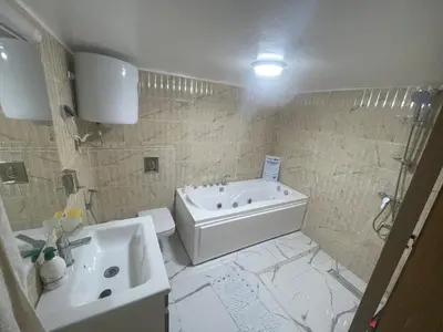 a bathroom with a tub and a toilet and a sink at Appartement downtown marrakech in Marrakech