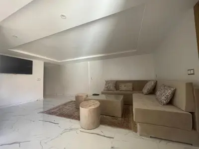 a living room with a couch and a table at Appartement downtown marrakech in Marrakech