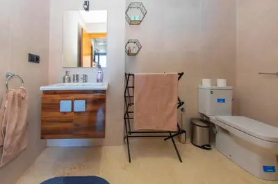 a bathroom with a sink and a toilet and a towel at New apartment with pool in Marrakech
