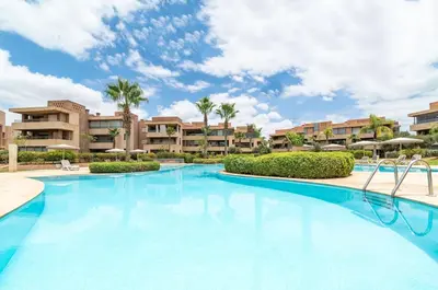 a swimming pool at a resort with palm trees at luxury, 4 pools et golf in prestigious in Marrakech