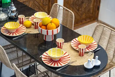 a black table with a bowl of fruit on it at Riad privatif 2 Chambres, Jacuzzi Proche des Palais in Marrakech