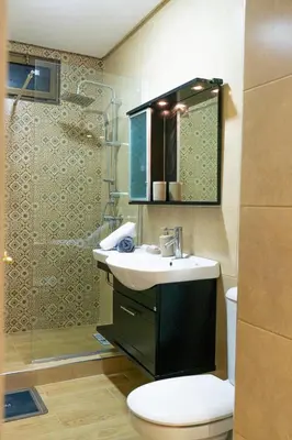 a bathroom with a sink and a toilet and a shower at Appartement Moderne à Marrakech in Marrakech