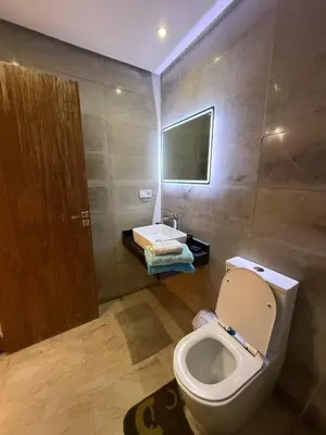 a bathroom with a toilet and a sink at Appartemen luxe in Marrakech