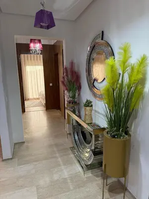 a hallway with potted plants and a mirror on the wall at Appartemen luxe in Marrakech
