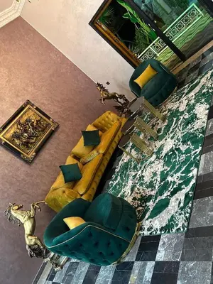 a living room with a yellow couch and chairs at Villa haut standig 2000 m2 in Marrakech