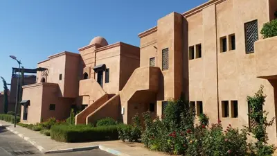 a building in the middle of a street at Atlas resort, 3 pools, roof terrace, holiday home in Marrakech