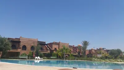 a resort with a swimming pool in front of a building at Atlas resort, 3 pools, roof terrace, holiday home in Marrakech
