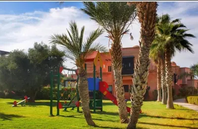 a playground with palm trees in a park at Atlas resort, 3 pools, roof terrace, holiday home in Marrakech