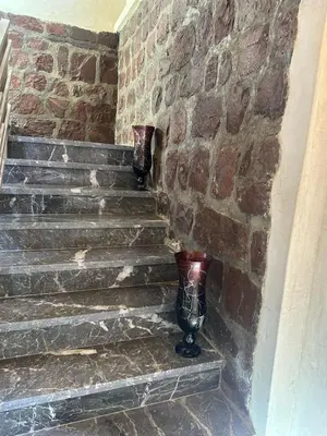 a set of stone stairs in a brick wall at villa ourika in Marrakech