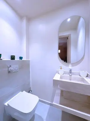 a bathroom with a toilet and a sink and a mirror at New! Duplex Annakhil , Calme et proximité centre in Marrakech