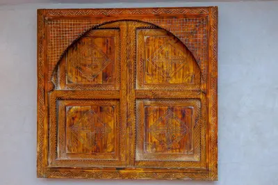 an old wooden door in a brick wall at Riad Akkioui in Marrakech