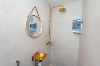a bathroom with a mirror and a sink at Riad Akkioui in Marrakech