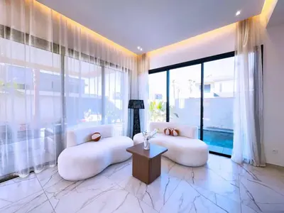 a living room with white furniture and large windows at villa Emna Design Contemporain & piscine chauffée in Marrakech